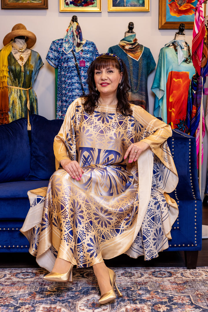 Designer Alesia Chaika in her Alesia C. SERENITY pure silk maxi caftan in a navy blue and gold. AlesiaC.com